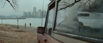 Movie still from “Three Days of the Condor” (1975), directed by Sydney Pollack – A view of a body of water from the side of a car; Extreme Wide shot, Over the shoulder angle