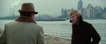 Movie still from “Three Days of the Condor” (1975), directed by Sydney Pollack – Two men standing on the beach looking at each other; Medium shot, Over the shoulder angle