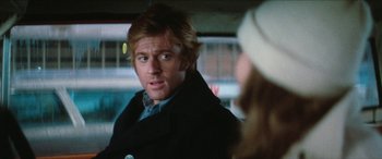 Movie still from “Three Days of the Condor” (1975), directed by Sydney Pollack – A person wearing a jacket; Close Up shot, Over the shoulder angle