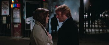 Movie still from “Three Days of the Condor” (1975), directed by Sydney Pollack – A man and a woman standing next to each other on a street; Close Up shot, Over the shoulder angle
