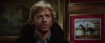 Movie still from “Three Days of the Condor” (1975), directed by Sydney Pollack – A person wearing a jacket; Close Up shot, Over the shoulder angle