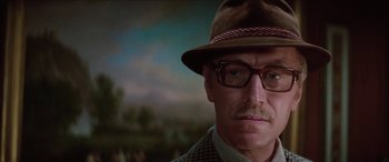 Movie still from “Three Days of the Condor” (1975), directed by Sydney Pollack – A person wearing glasses and a hat; Close Up shot, Low angle