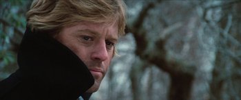 Movie still from “Three Days of the Condor” (1975), directed by Sydney Pollack – A person talking on a cell phone; Close Up shot, Low angle