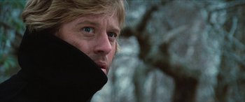 Movie still from “Three Days of the Condor” (1975), directed by Sydney Pollack – A person wearing a black jacket; Close Up shot, Low angle