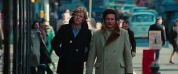 Movie still from “Three Days of the Condor” (1975), directed by Sydney Pollack – Two men walking down the street wearing coats and hats; Medium shot, Low angle