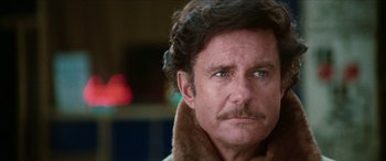 Movie still from “Three Days of the Condor” (1975), directed by Sydney Pollack – A person wearing a jacket; Close Up shot, Over the shoulder angle