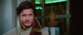 Movie still from “Three Days of the Condor” (1975), directed by Sydney Pollack – A man wearing a coat and a fur collar; Close Up shot, Low angle