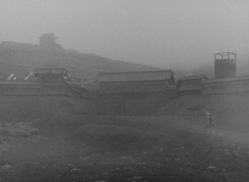 Movie still from “Throne of Blood” (1957), directed by Akira Kurosawa – A black - and - white photo of a mountain in the fog; Extreme Wide shot, Low angle