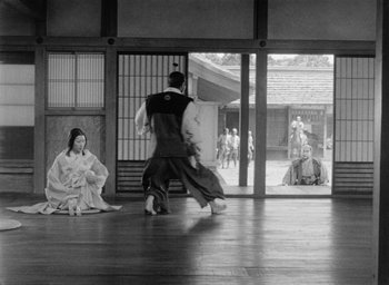 Movie still from “Throne of Blood” (1957), directed by Akira Kurosawa – A couple of people that are dancing in a room; Extreme Wide shot, Low angle