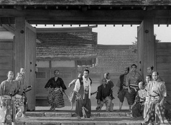 Movie still from “Throne of Blood” (1957), directed by Akira Kurosawa – A black and white photo of a group of people; Wide shot, Low angle