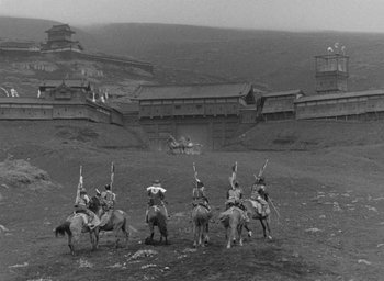 Movie still from “Throne of Blood” (1957), directed by Akira Kurosawa – A black and white photo of people on horseback; Extreme Wide shot, High angle