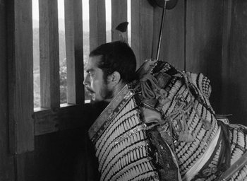 Movie still from “Throne of Blood” (1957), directed by Akira Kurosawa – A man with a bag on his back; Medium shot, Low angle