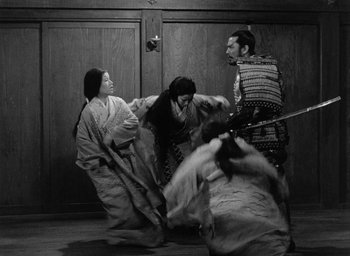 Movie still from “Throne of Blood” (1957), directed by Akira Kurosawa – A group of people in traditional japanese garb fighting; Wide shot, Low angle