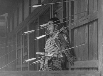 Movie still from “Throne of Blood” (1957), directed by Akira Kurosawa – An old photo of a man in a samurai outfit; Medium shot, Low angle