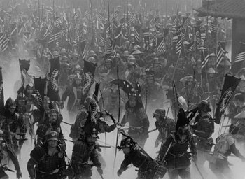 Movie still from “Throne of Blood” (1957), directed by Akira Kurosawa – A black and white photo of a large group of people marching; Extreme Wide shot, High angle