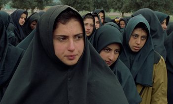 Movie still from “Through the Olive Trees” (1994), directed by Abbas Kiarostami – A group of women in a line wearing black robes; Close Up shot, High angle