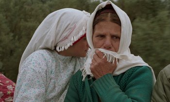 Movie still from “Through the Olive Trees” (1994), directed by Abbas Kiarostami – Two women one of whom is covering her face with a scarf; Close Up shot, Over the shoulder angle