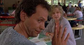 Movie still from “Throw Momma from the Train” (1987), directed by Danny DeVito – A man and a woman sitting at a table with food; Close Up shot, Over the shoulder angle