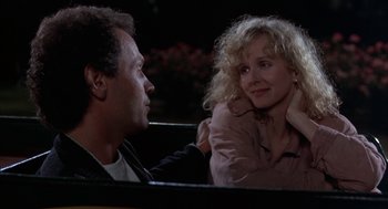 Movie still from “Throw Momma from the Train” (1987), directed by Danny DeVito – A man and a woman sitting next to each other in a car; Close Up shot, Over the shoulder angle