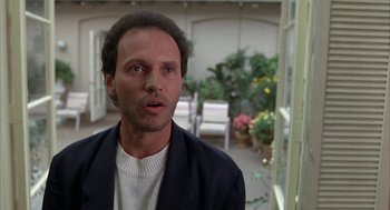 Movie still from “Throw Momma from the Train” (1987), directed by Danny DeVito – A person wearing a suit jacket; Close Up shot, Low angle