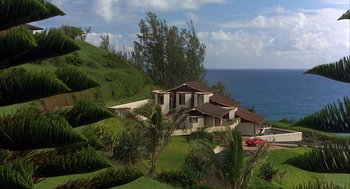 Movie still from “Throw Momma from the Train” (1987), directed by Danny DeVito – A house on a hill overlooking the ocean; Extreme Wide shot, High angle