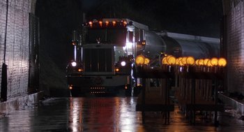 Movie still from “Throw Momma from the Train” (1987), directed by Danny DeVito – A truck driving down a street at night; Extreme Wide shot, Low angle