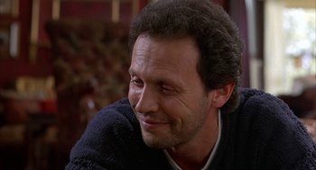 Movie still from “Throw Momma from the Train” (1987), directed by Danny DeVito – A person sitting in a chair; Close Up shot, Low angle