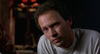 Movie still from “Throw Momma from the Train” (1987), directed by Danny DeVito – A person sitting down with his eyes closed; Close Up shot, Low angle