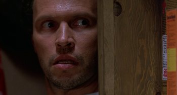 Movie still from “Throw Momma from the Train” (1987), directed by Danny DeVito – A man's face looking at the camera; Close Up shot, Low angle