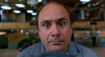 Movie still from “Throw Momma from the Train” (1987), directed by Danny DeVito – A person with a surprised look on his face; Close Up shot, Low angle