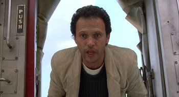 Movie still from “Throw Momma from the Train” (1987), directed by Danny DeVito – A person wearing a jacket looking at the camera; Close Up shot, Low angle