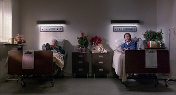 Movie still from “Throw Momma from the Train” (1987), directed by Danny DeVito – Two men sitting in a hospital bed next to each other; Wide shot, High angle
