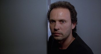 Movie still from “Throw Momma from the Train” (1987), directed by Danny DeVito – A person wearing a black t - shirt; Close Up shot, Low angle