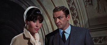 Movie still from “Thunderball” (1965), directed by Terence Young – A man and a woman standing next to each other; Close Up shot, Low angle
