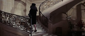 Movie still from “Thunderball” (1965), directed by Terence Young – A woman walking up a set of stairs; Wide shot, High angle