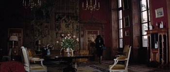 Movie still from “Thunderball” (1965), directed by Terence Young – A woman walking in a room with a vase of flowers; Wide shot, High angle