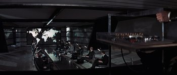 Movie still from “Thunderball” (1965), directed by Terence Young – A group of men sitting at a table working on laptops; Extreme Wide shot, High angle