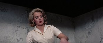Movie still from “Thunderball” (1965), directed by Terence Young – A woman in a white shirt is looking at the camera; Medium shot, Low angle