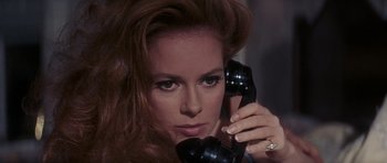 Movie still from “Thunderball” (1965), directed by Terence Young – A woman holding a phone up to her ear; Close Up shot, High angle