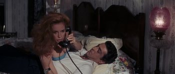 Movie still from “Thunderball” (1965), directed by Terence Young – A man laying in a bed next to a woman; Medium shot, High angle