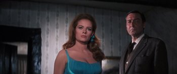 Movie still from “Thunderball” (1965), directed by Terence Young – A woman in a blue dress with a blue earring; Medium shot, Low angle