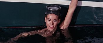 Movie still from “Thunderball” (1965), directed by Terence Young – A woman in a swimming pool with a bucket on her head; Close Up shot, High angle