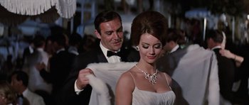 Movie still from “Thunderball” (1965), directed by Terence Young – A man and a woman dressed in formal wear; Medium shot, Low angle