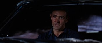Movie still from “Thunderball” (1965), directed by Terence Young – A person sitting in a car; Close Up shot, Over the shoulder angle