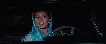 Movie still from “Thunderball” (1965), directed by Terence Young – A woman sitting in the drivers seat of a car; Close Up shot, Low angle