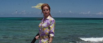Movie still from “Thunderball” (1965), directed by Terence Young – A woman standing on the beach in front of the ocean; Medium shot, Low angle