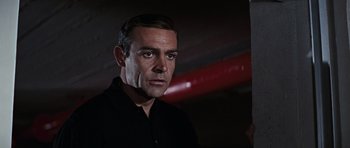 Movie still from “Thunderball” (1965), directed by Terence Young – A person wearing a black shirt; Close Up shot, Low angle