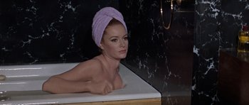 Movie still from “Thunderball” (1965), directed by Terence Young – A woman with a towel wrapped around her head is taking a bath in a tub; Close Up shot, High angle
