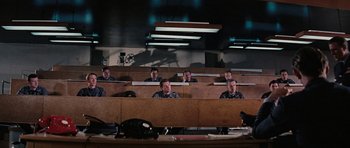 Movie still from “Thunderball” (1965), directed by Terence Young – A group of men sitting in a lecture hall; Wide shot, High angle