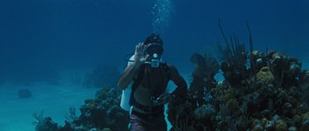 Movie still from “Thunderball” (1965), directed by Terence Young – A scuba diver taking a picture in the water; Wide shot, High angle